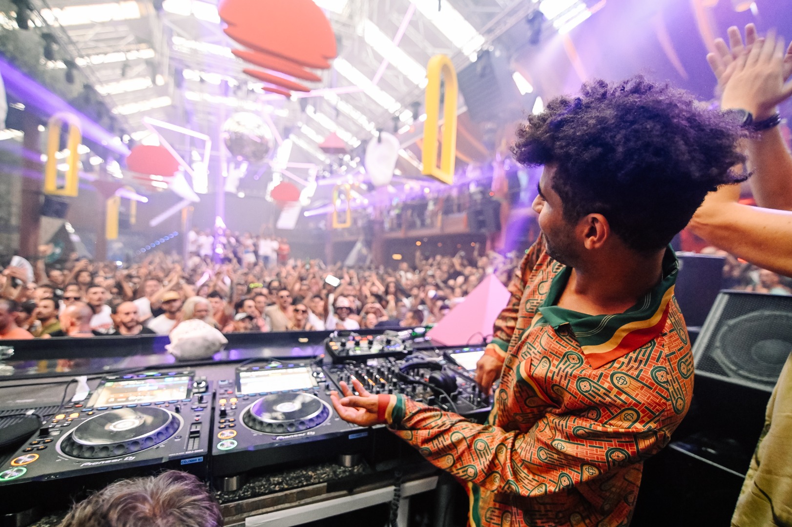 a dj in front of a crowd at a concert