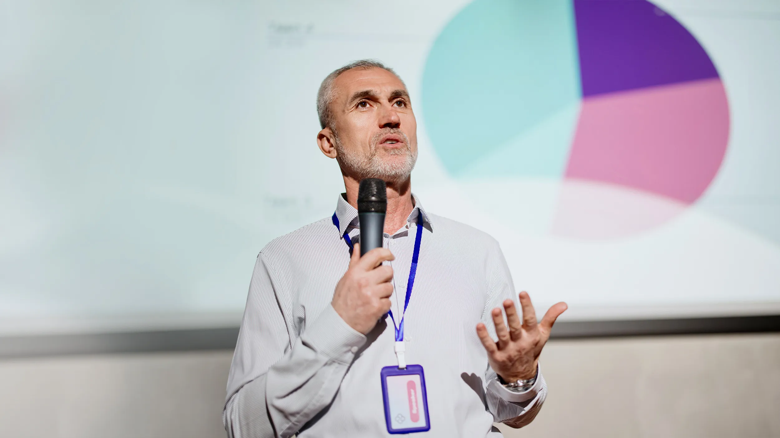 Man presenting with graph and microphone