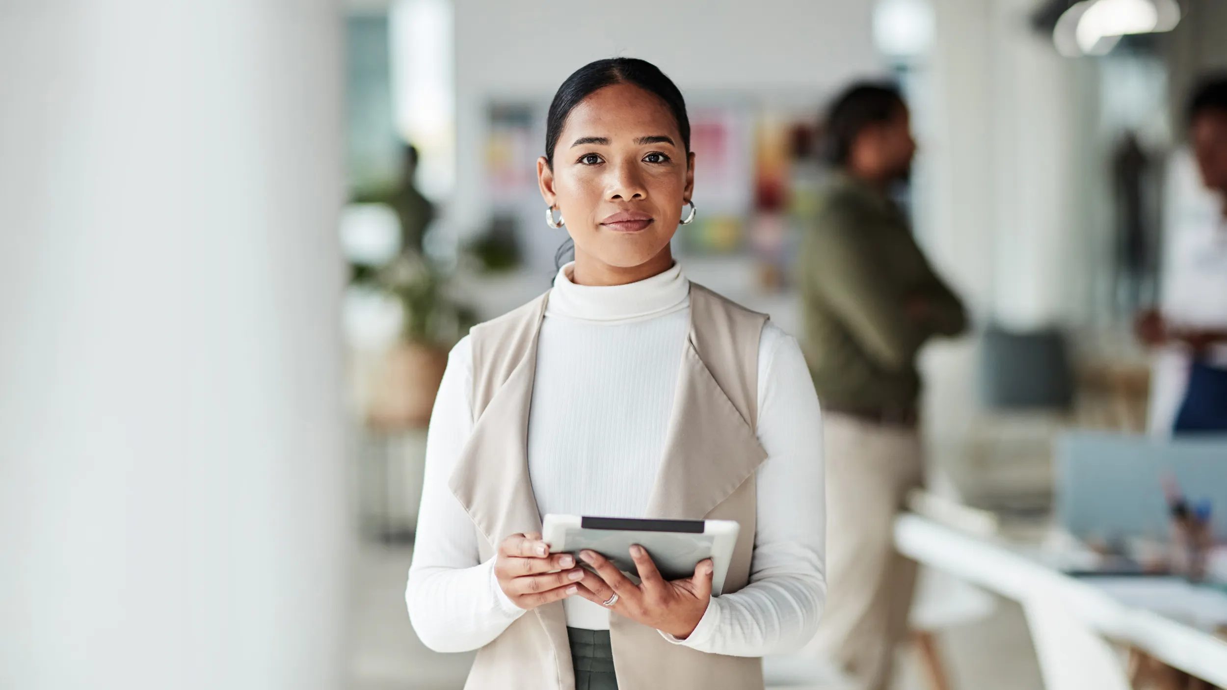 Confident leader in office with tablet