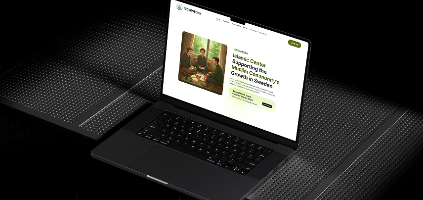 A laptop on a dark desktop showing the clean and modern design for the ICCS website.