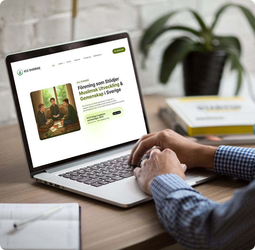 Person working on a laptop displaying the home page of ICCS new website.