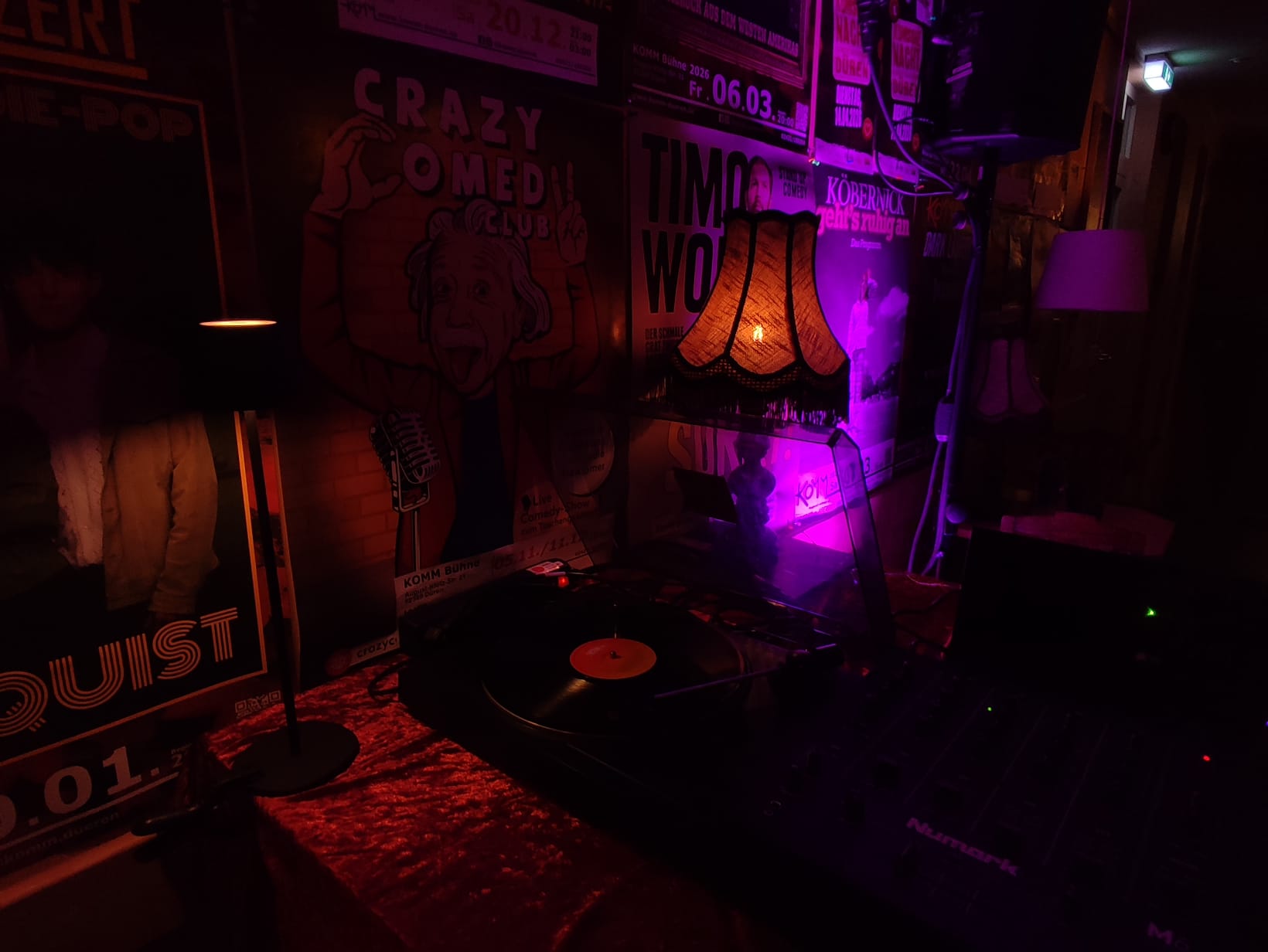 Text "KOMM Auflegen!" und "Open Vinyl Bar" vor einem Hintergrund mit Schallplatten 