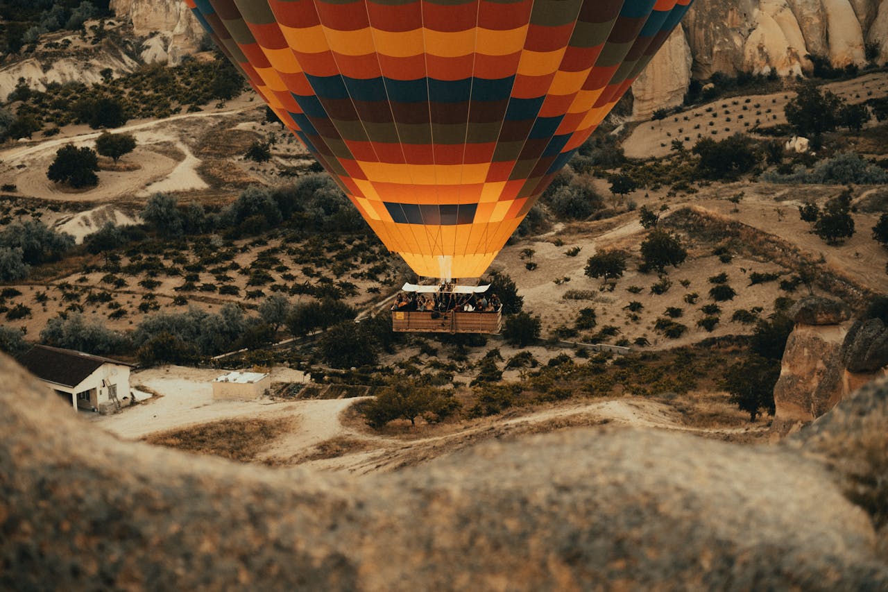 A hot air balloon flying over a mountain range.