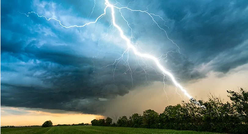 A large cloud with a lightning bolt in the sky.