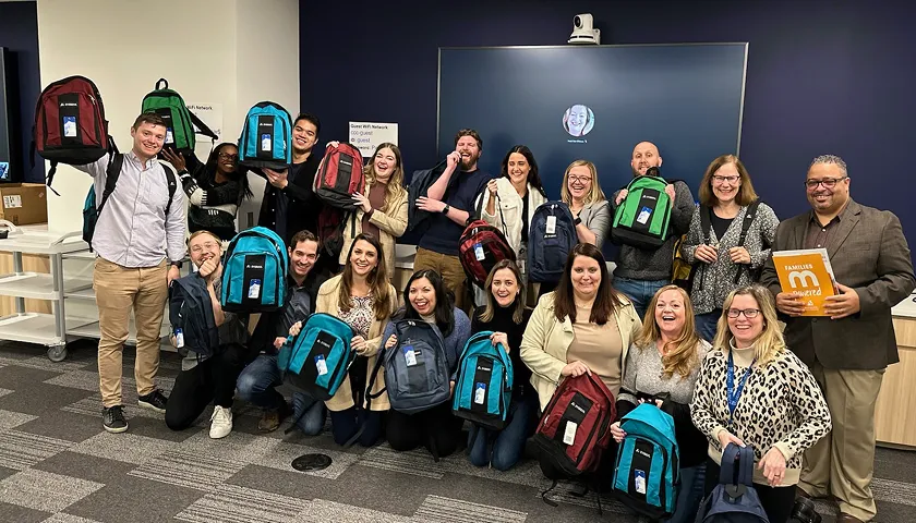 A group of people with backpacks posing for a picture.