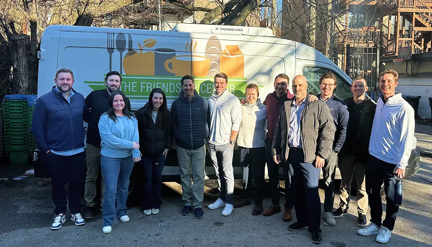A group of people standing in front of a van.