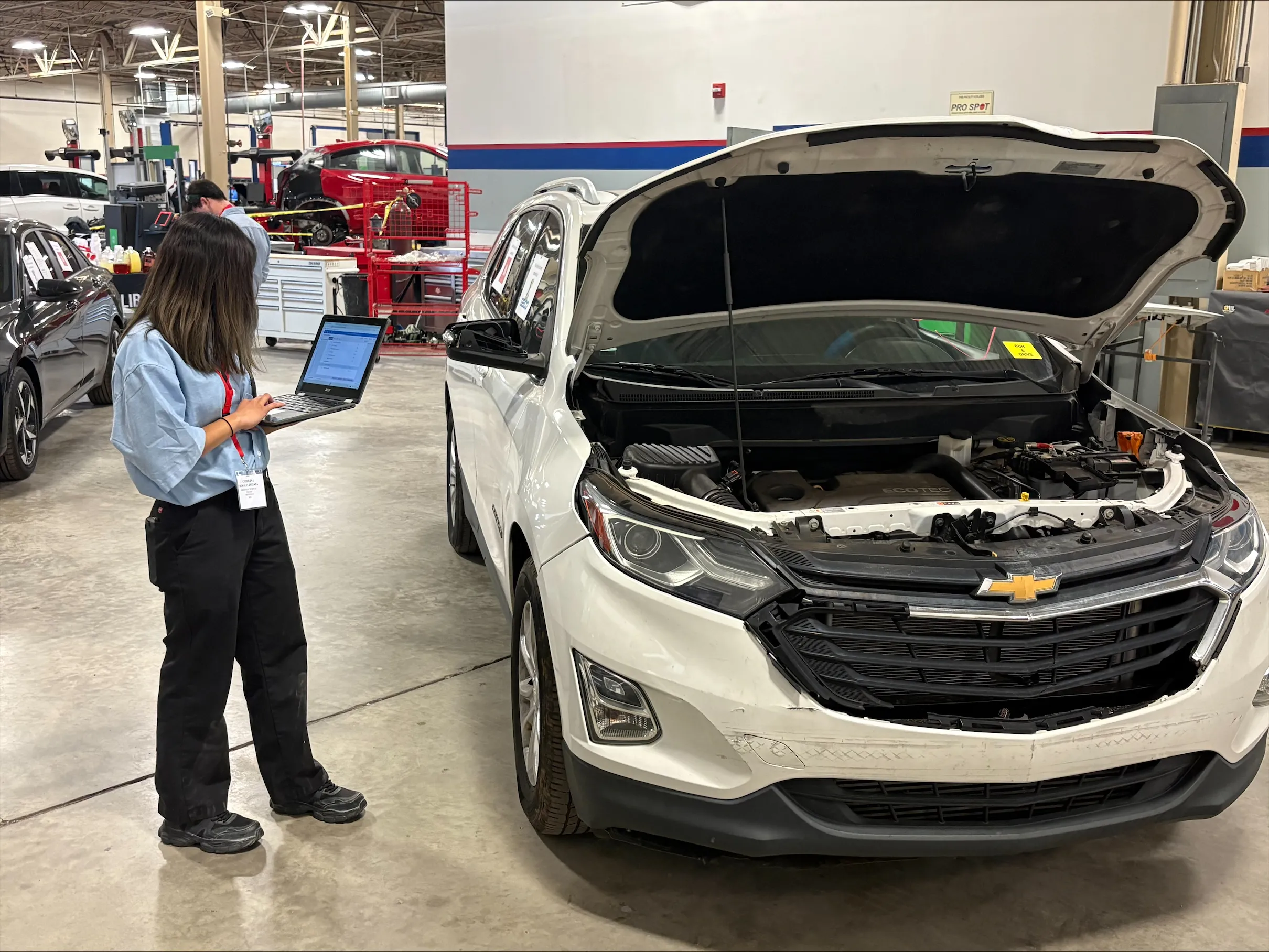A man and a woman sitting at a table in front of computers.