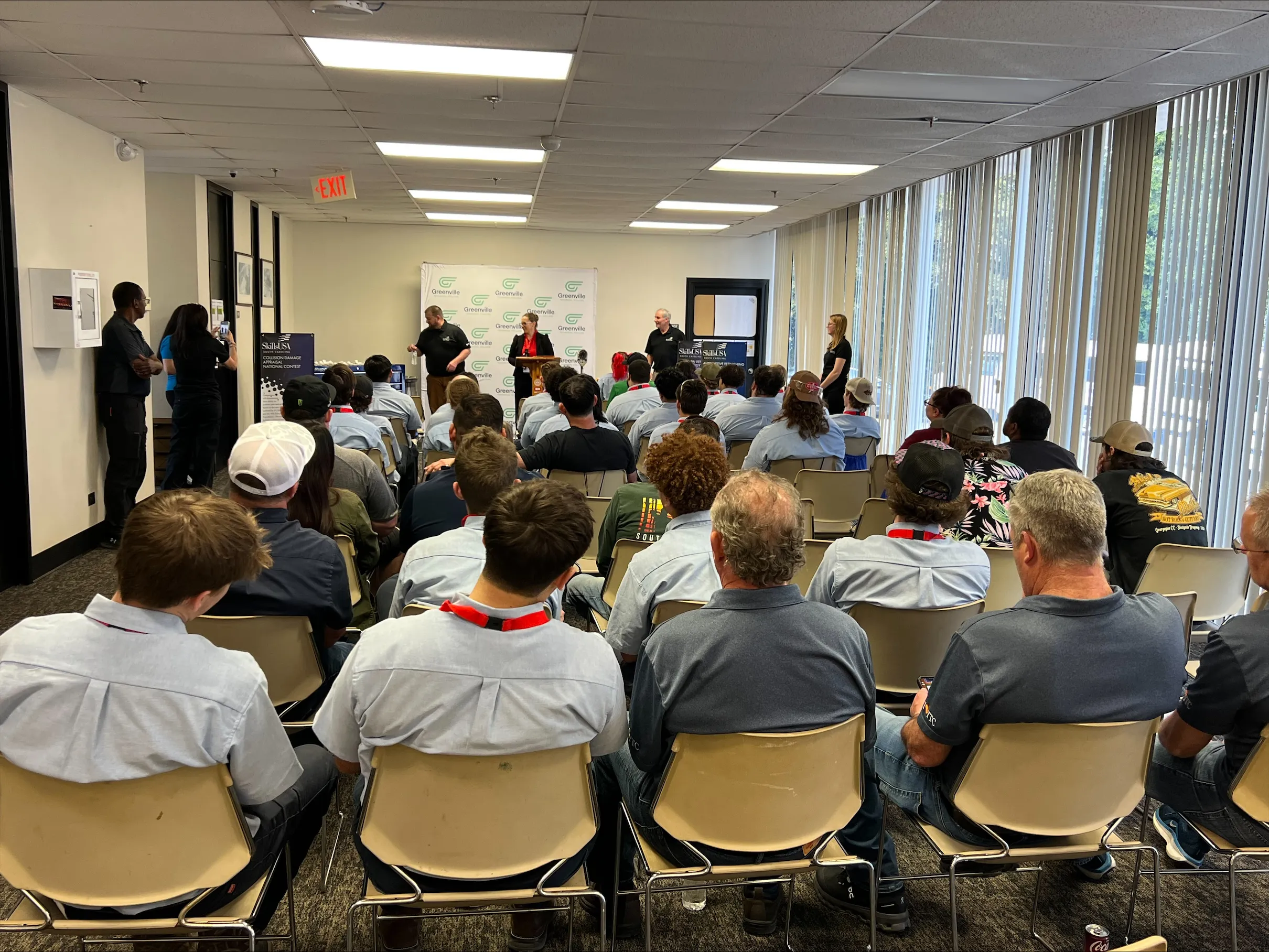 A group of people standing around a table.