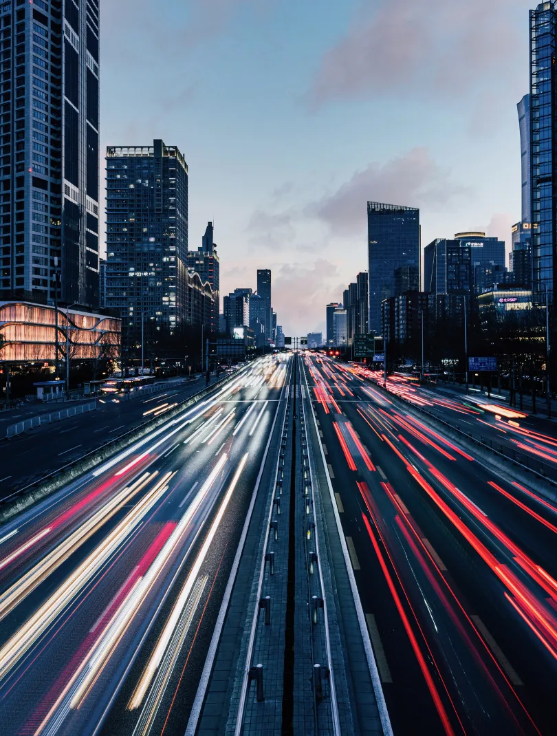 A car driving down a highway at night.