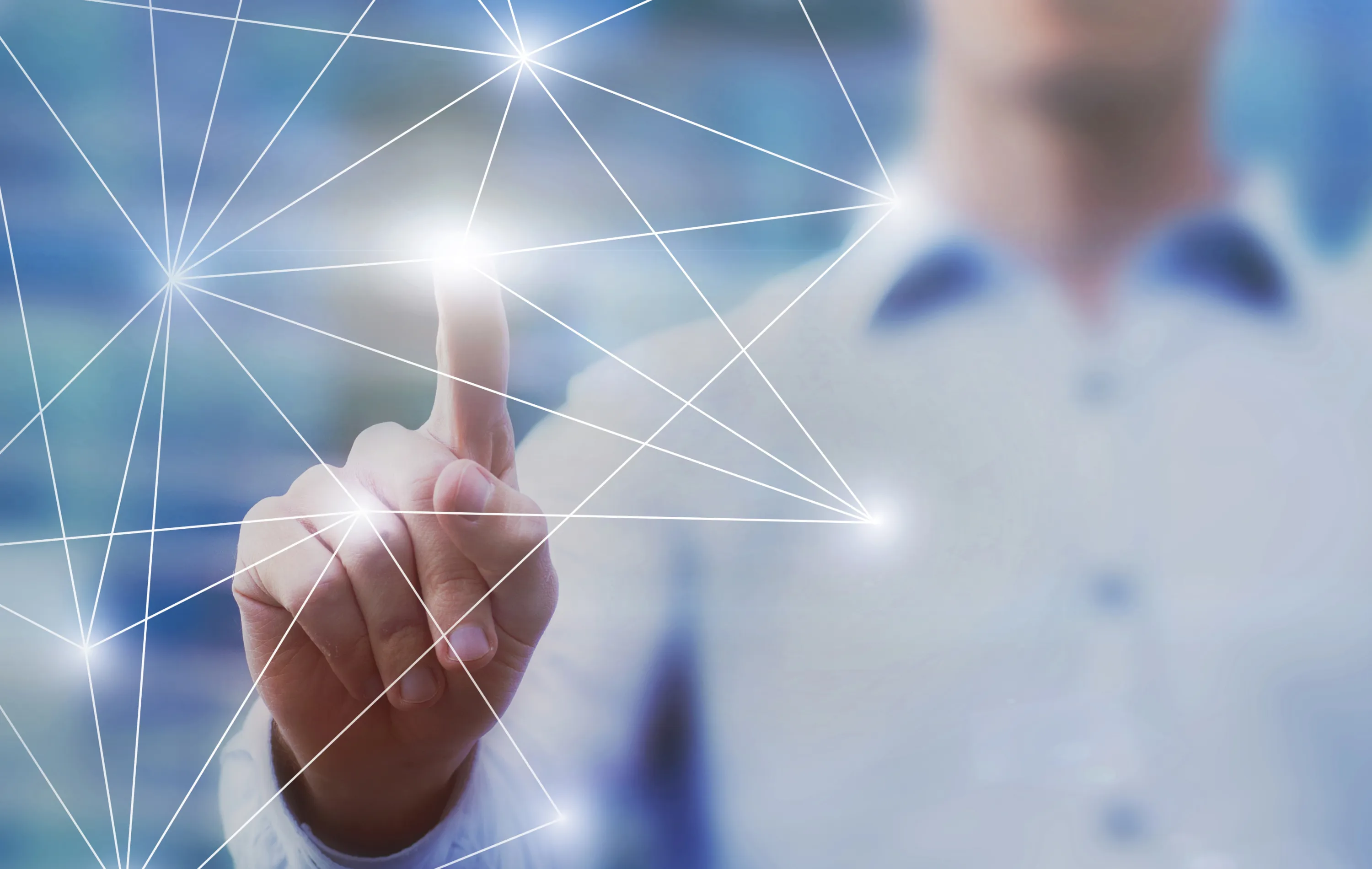 Person in white shirt touching a glowing point on a digital network of connected lines and nodes.
