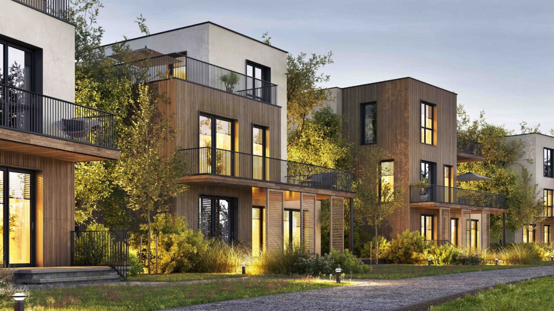 Moderne Reihenhäuser mit Holzfassade und großen Balkonen in ruhiger Wohngegend