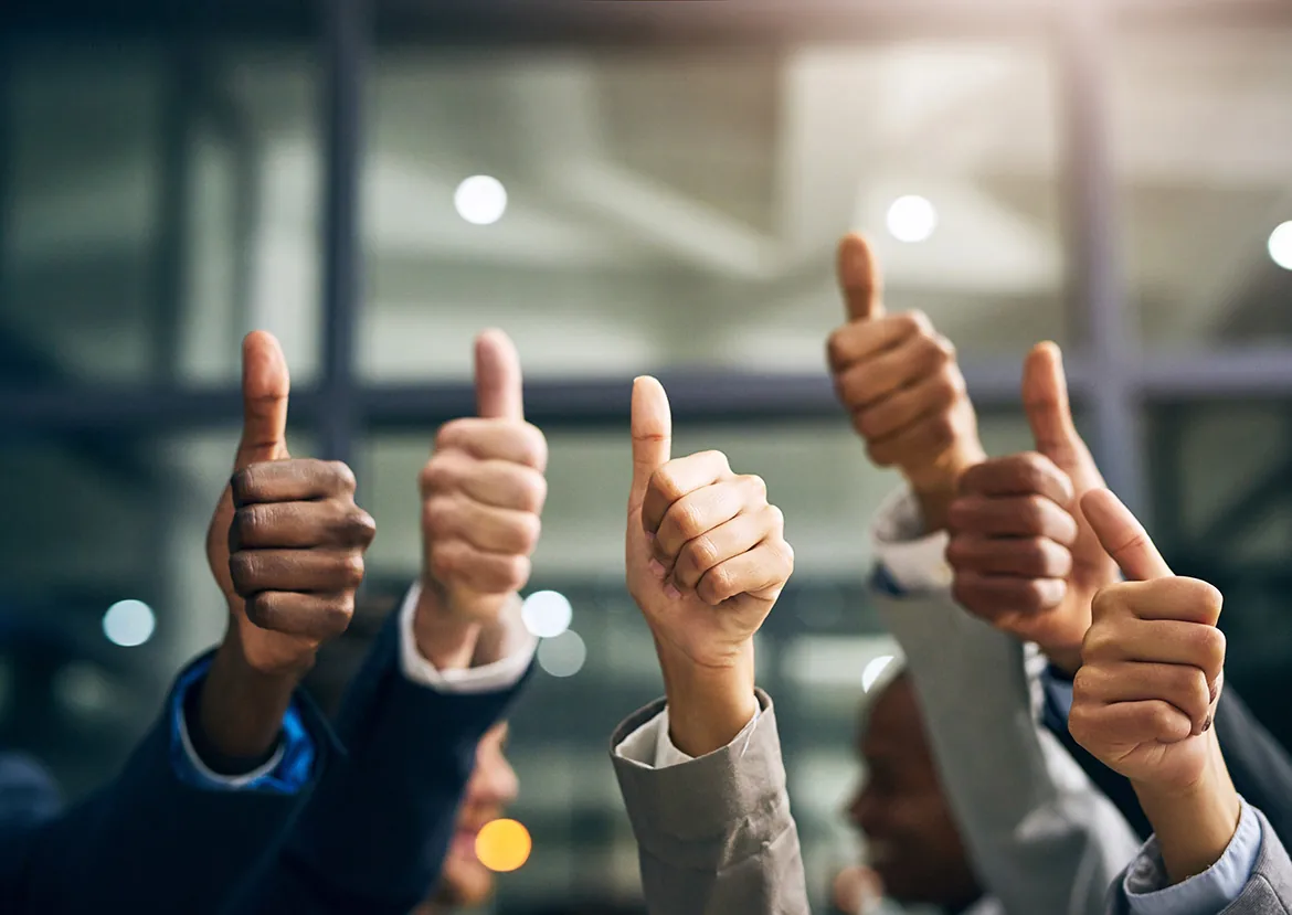 A group of people giving thumbs up.