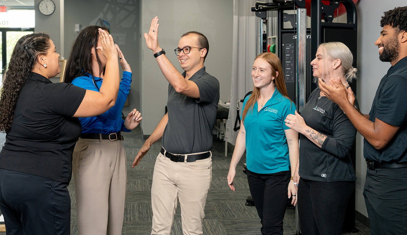 CORA Physical Therapy teammates sharing a positive moment at work