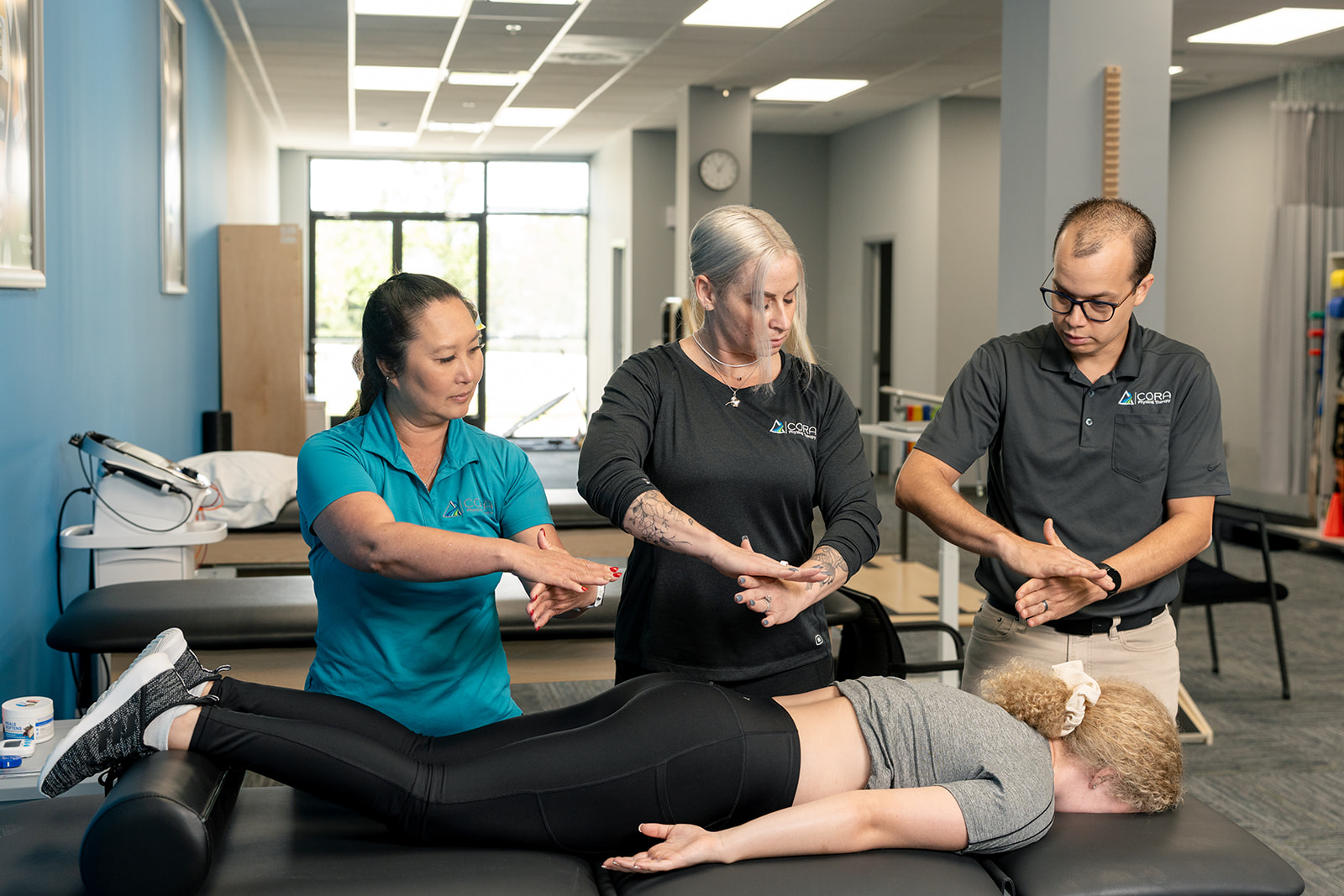 Physical therapists practicing a thoracic spine and rib cage evaluation