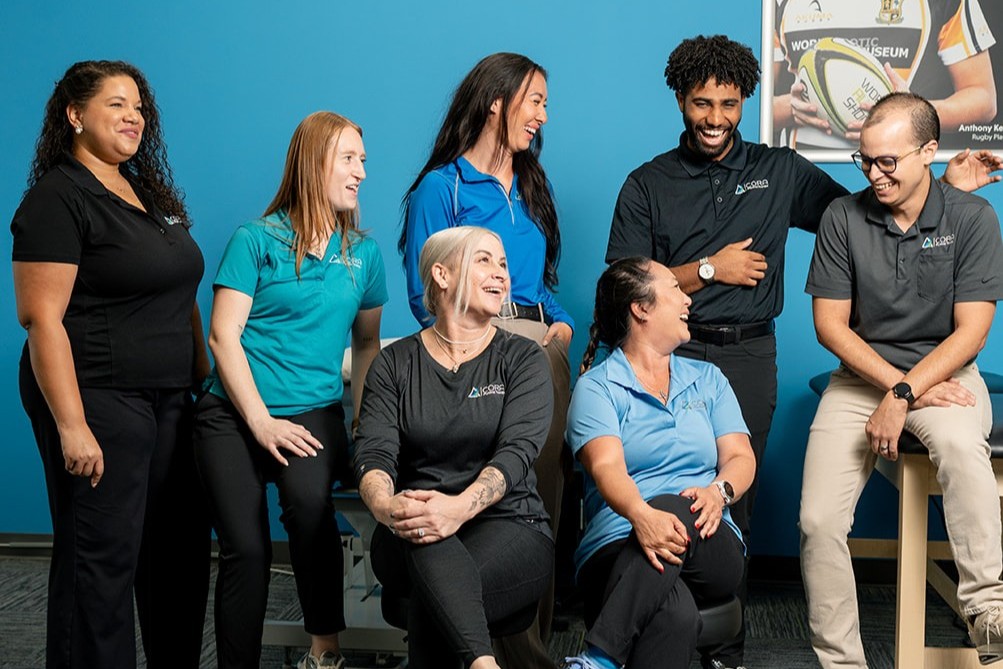 CORA Physical Therapists together in a clinic laughing