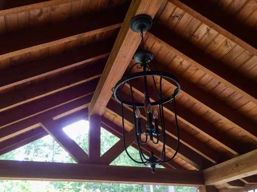 beautiful custom woodwork ceiling for cabin interior remodel with fancy light fixture