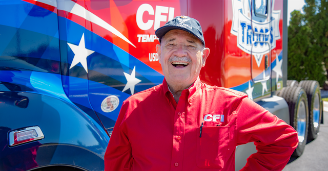 Picture of a driver in front of a truck