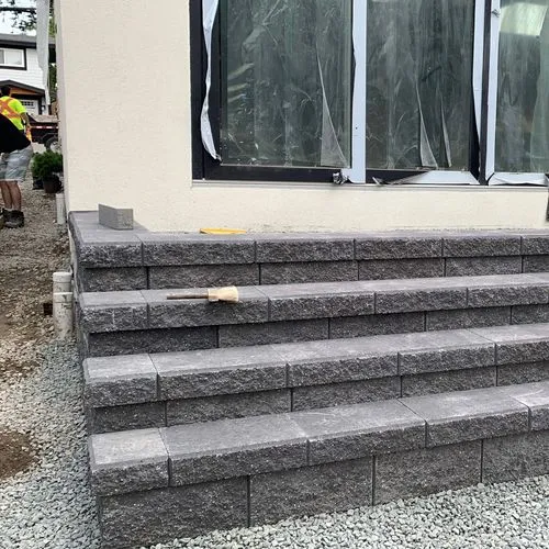 Freshly constructed concrete block steps leading to house entrance, still under construction