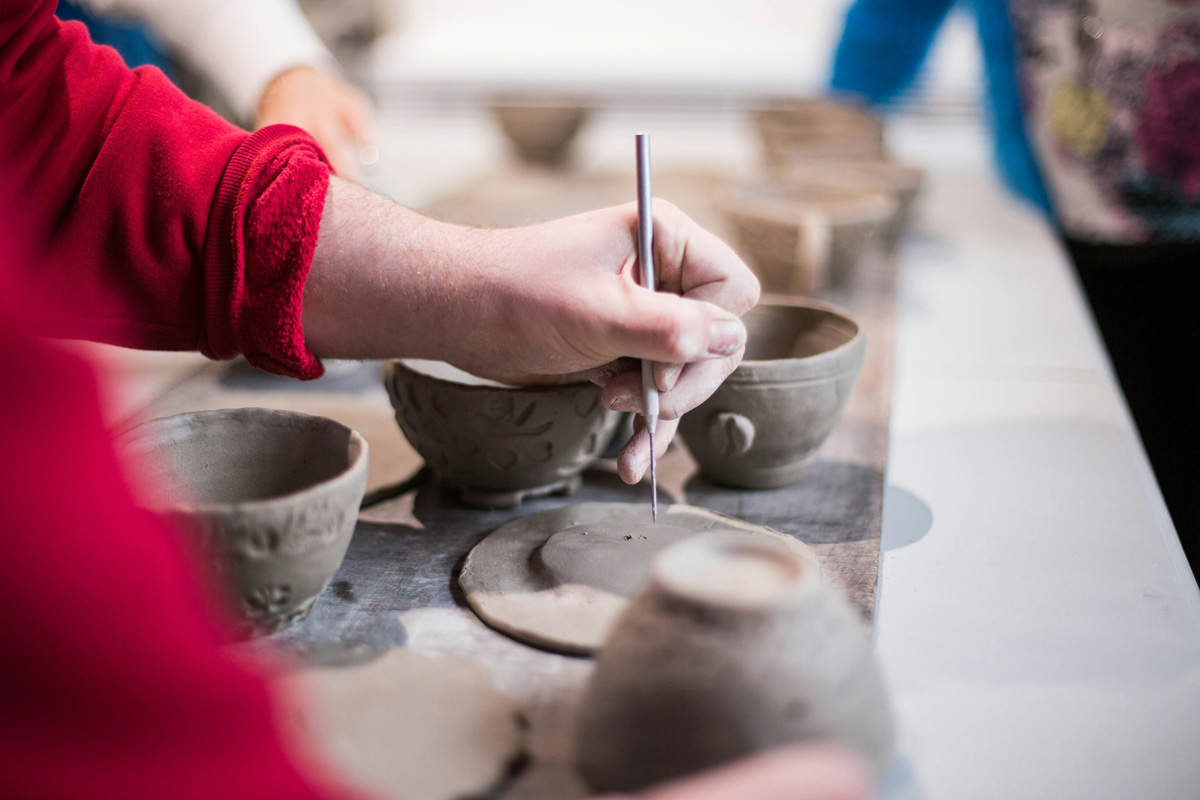 Close-up of hands making ceramics.