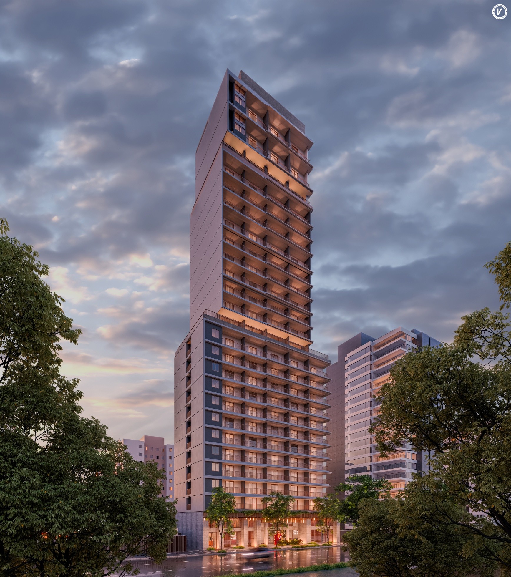 Tall modern apartment building illuminated at dusk with other buildings and trees under a cloudy sky.