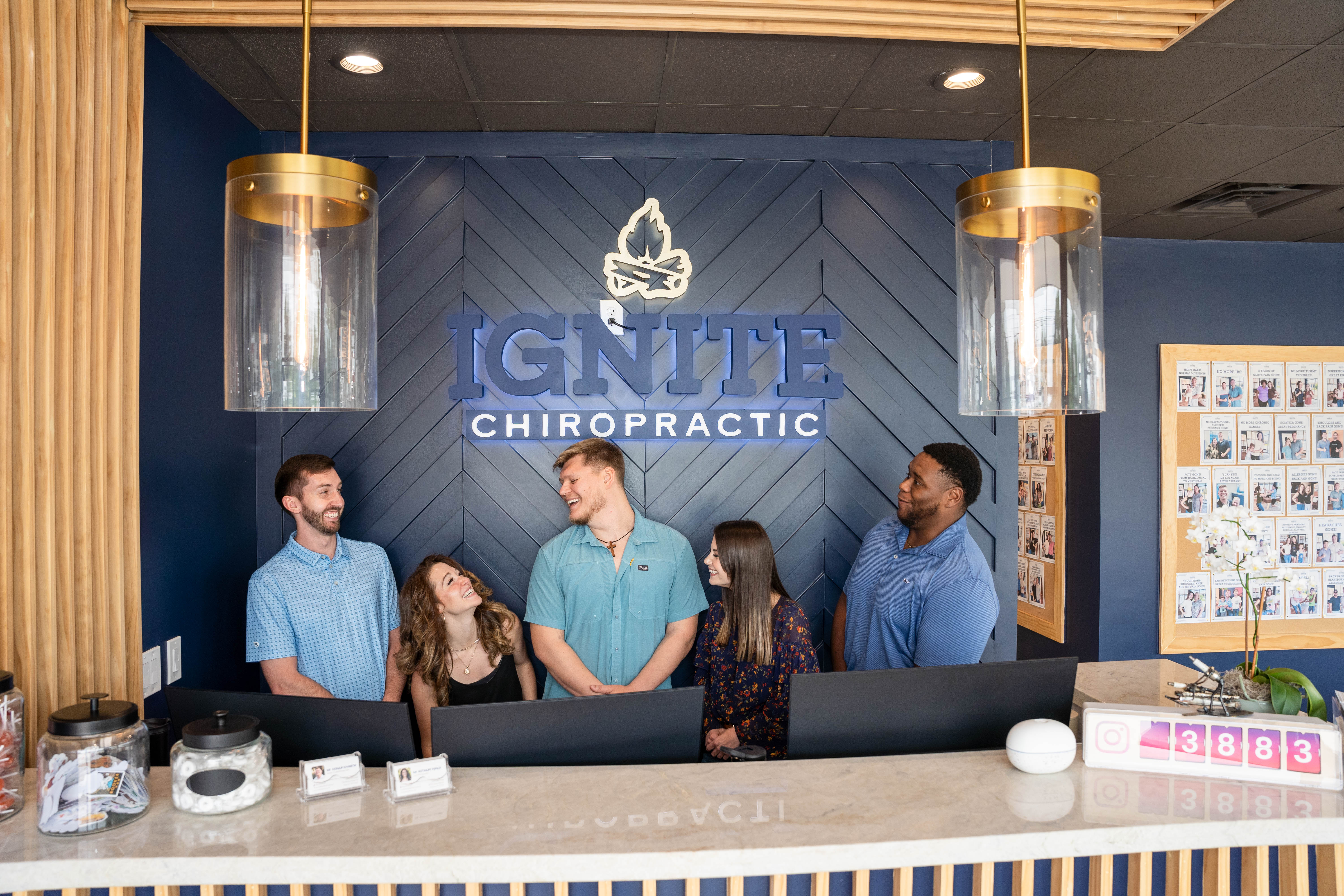 Friendly staff greeting clients at Ignite Chiropractic clinic reception in Cypress, TX, offering expert chiropractic servi...