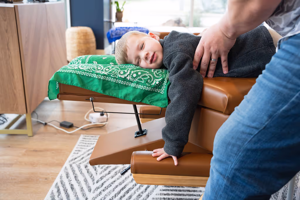Child with ear infection receiving gentle chiropractic care for natural drainage support