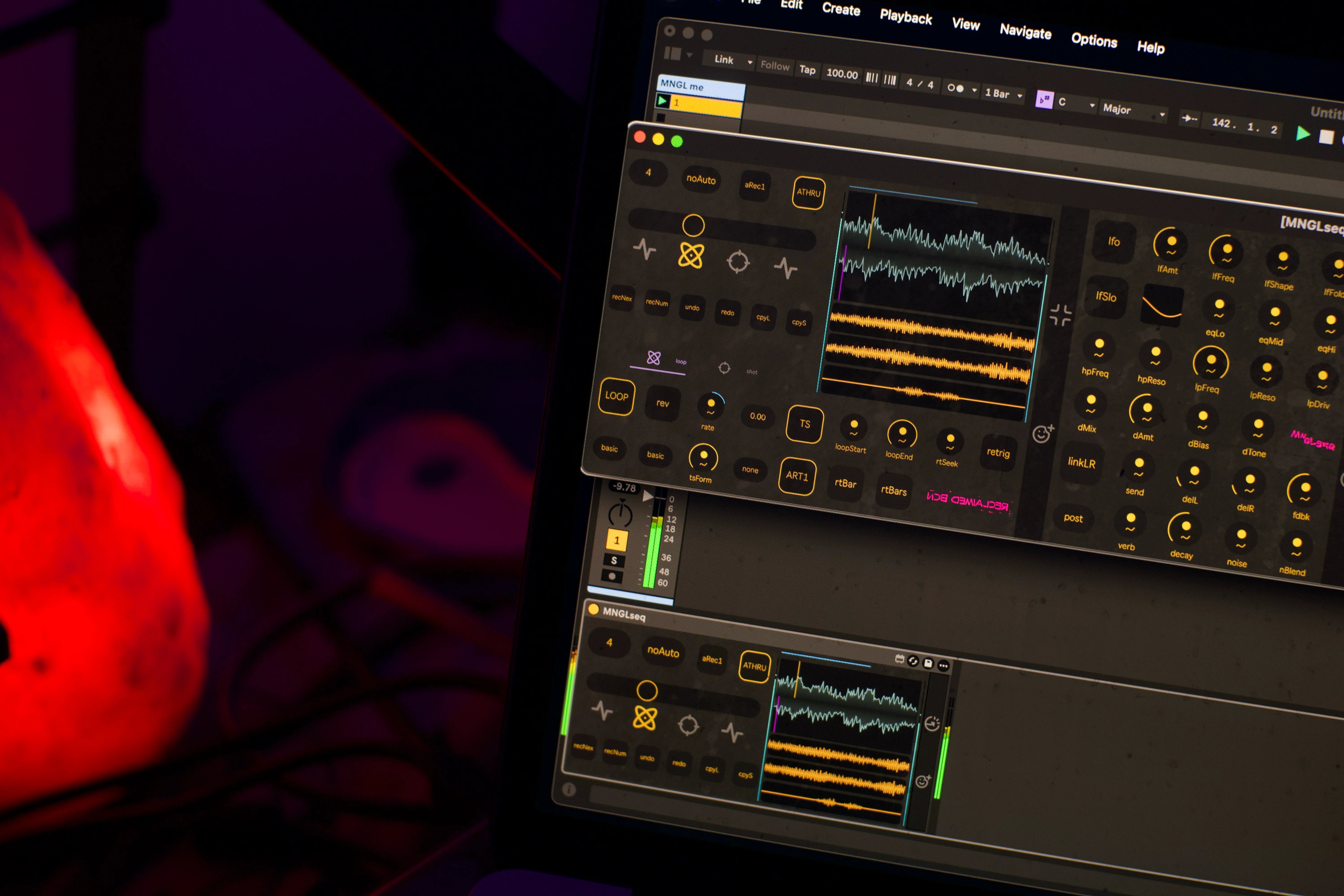 MNGLseq Max for Live device running on a music producers macbook and Ableton Live. Sample waveforms and audio visualisations can be seen on the UI (user interface)