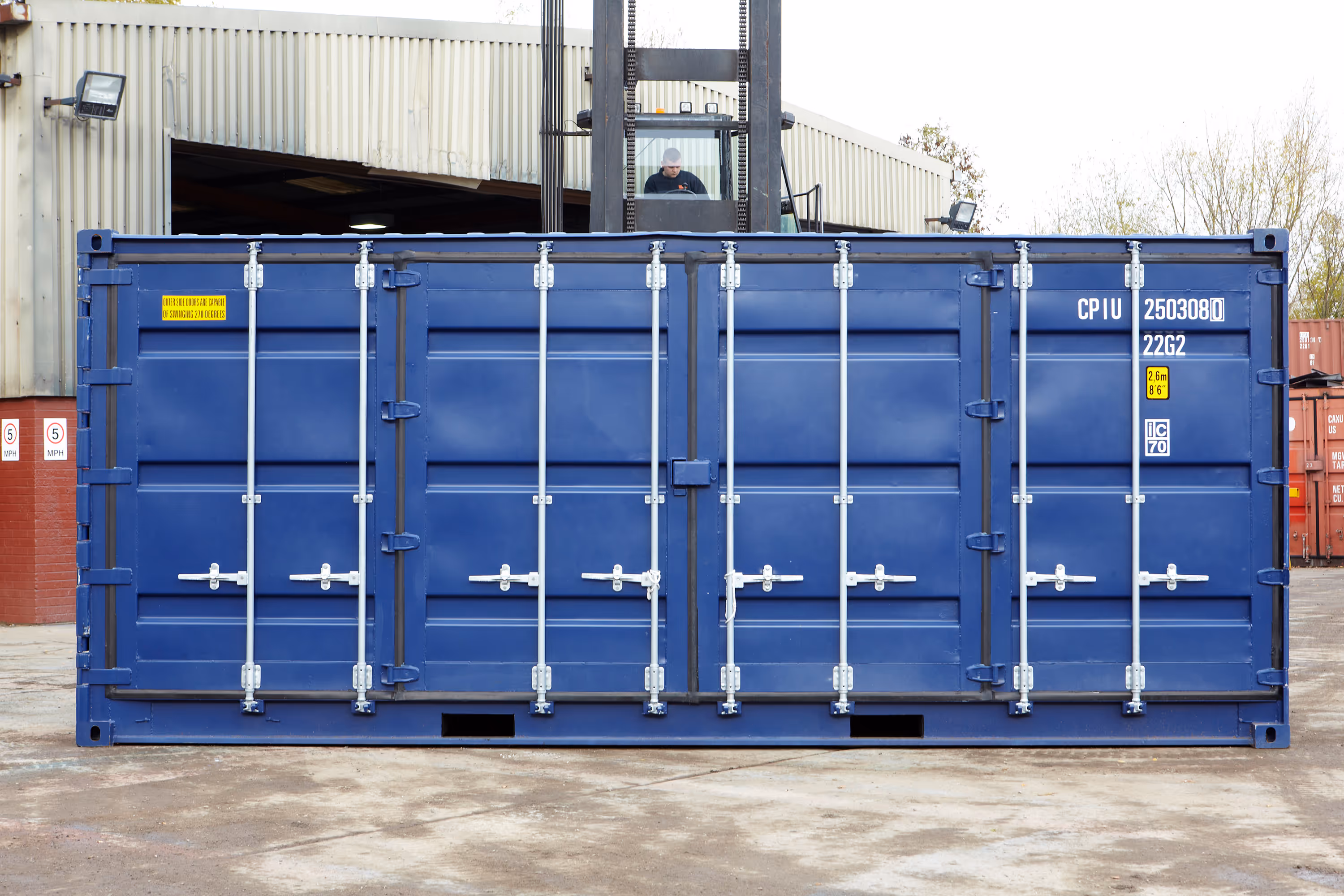 A blue container with white handles.