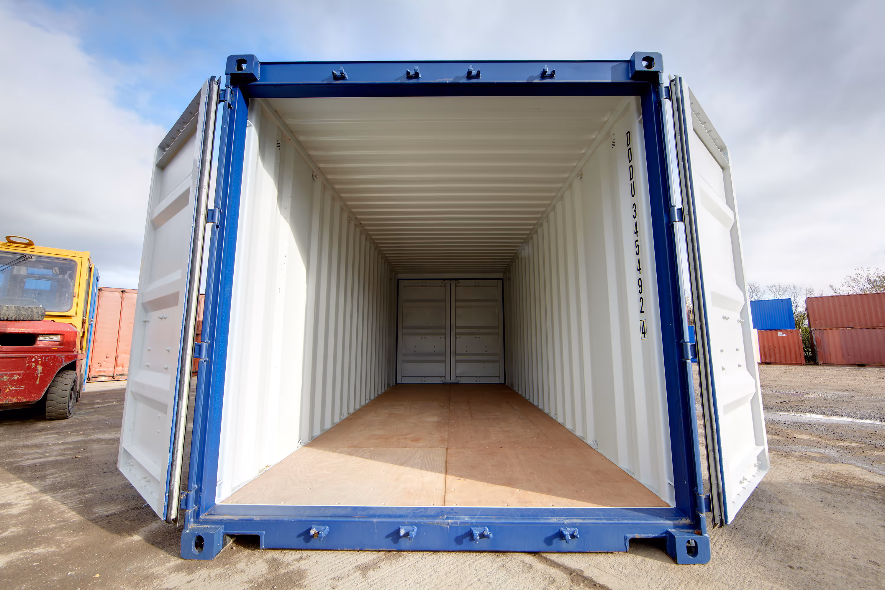 A large blue shipping container with a white door.