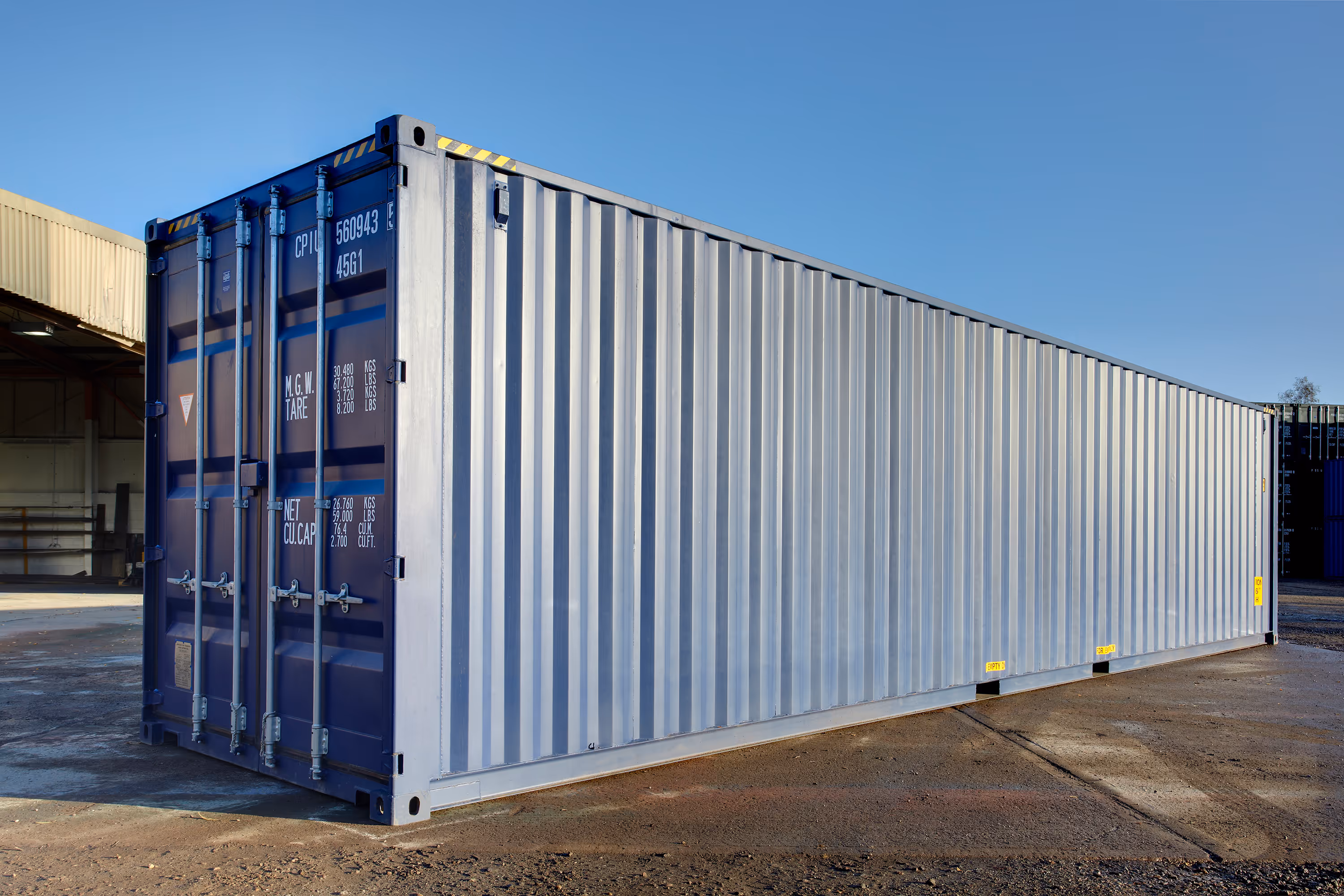 A large blue shipping container with a yellow stripe.