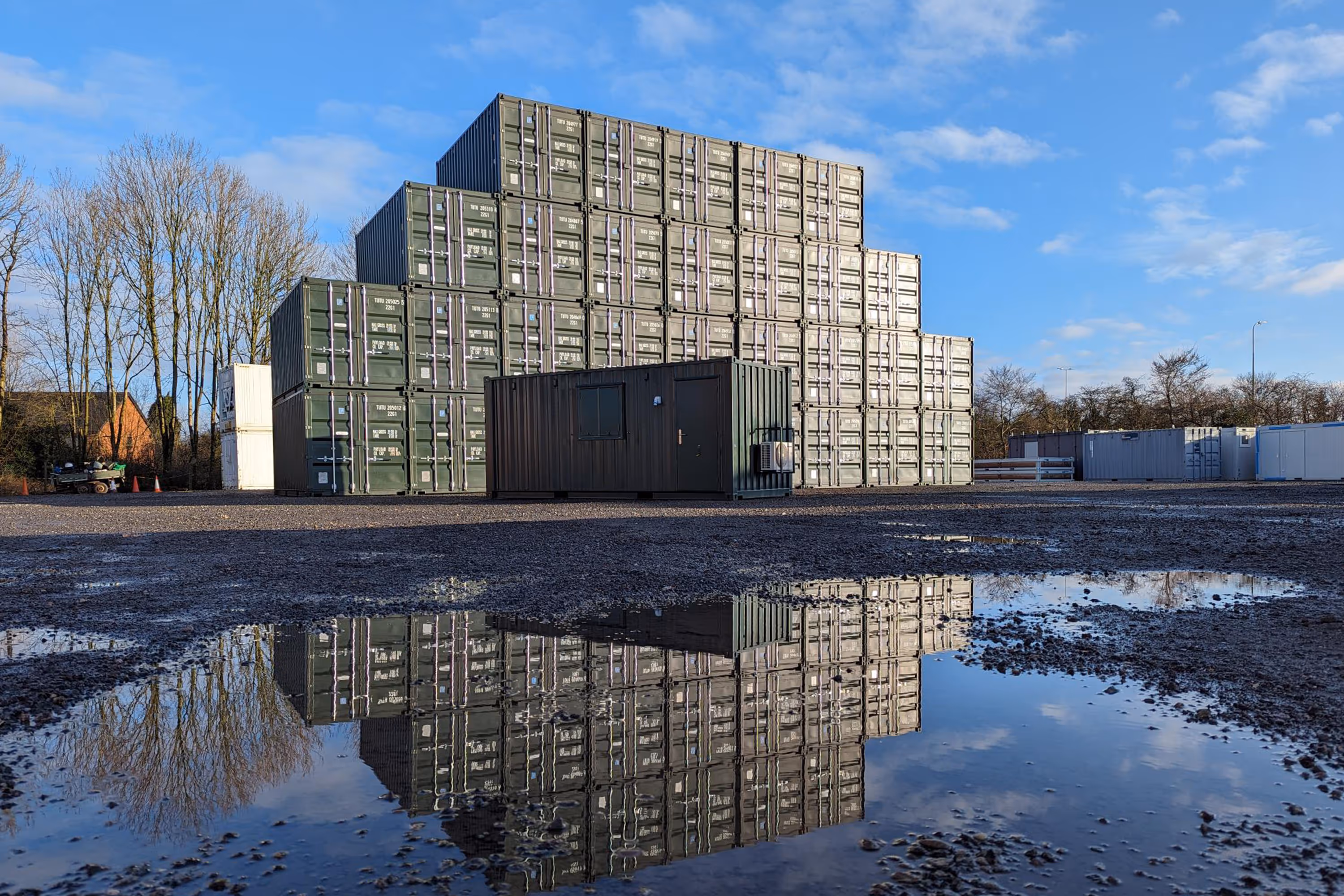 A large building with a reflection of a building in the water.