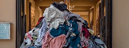 Overflowing laundry basket outside a nail spa storefront, illustrating how undone laundry takes over your day