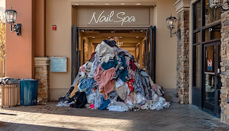 Overflowing laundry basket outside a nail spa storefront, illustrating how undone laundry takes over your day