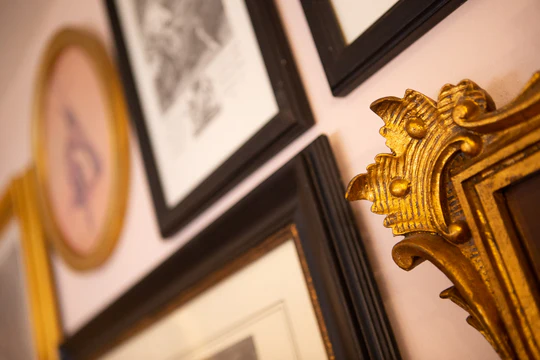 An image of multiple picture frames on the wall