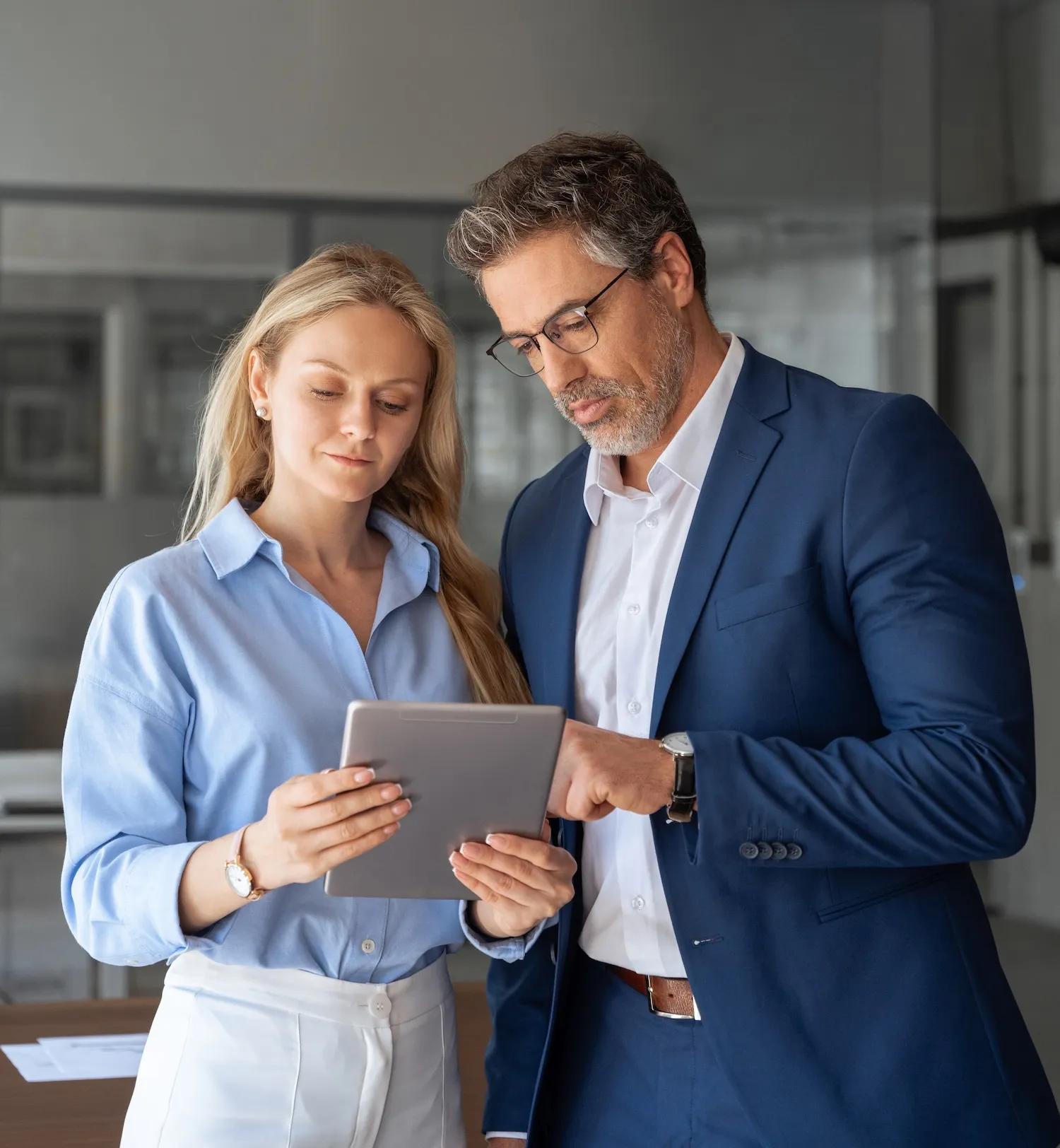 People engaged in a discussion while reviewing a presentation on a tablet, sharing ideas and feedback