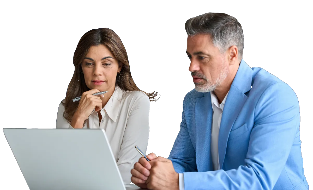 Man in blue blazer and woman in white shirt looking at laptop screen together.