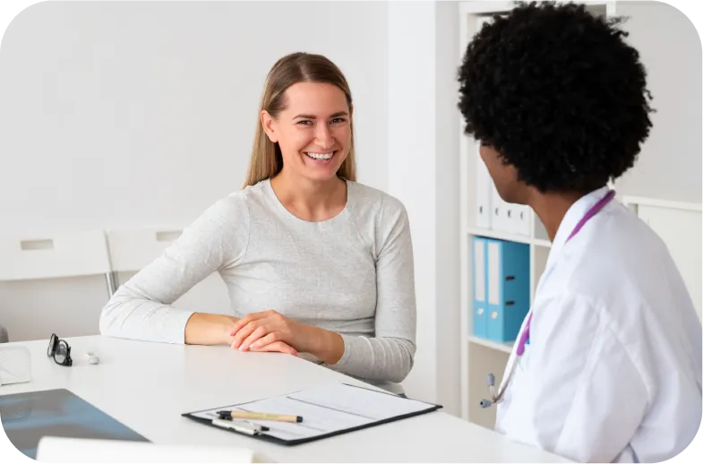 A healthcare professional meets with a patient or family member to discuss available medical treatments, support, or services.