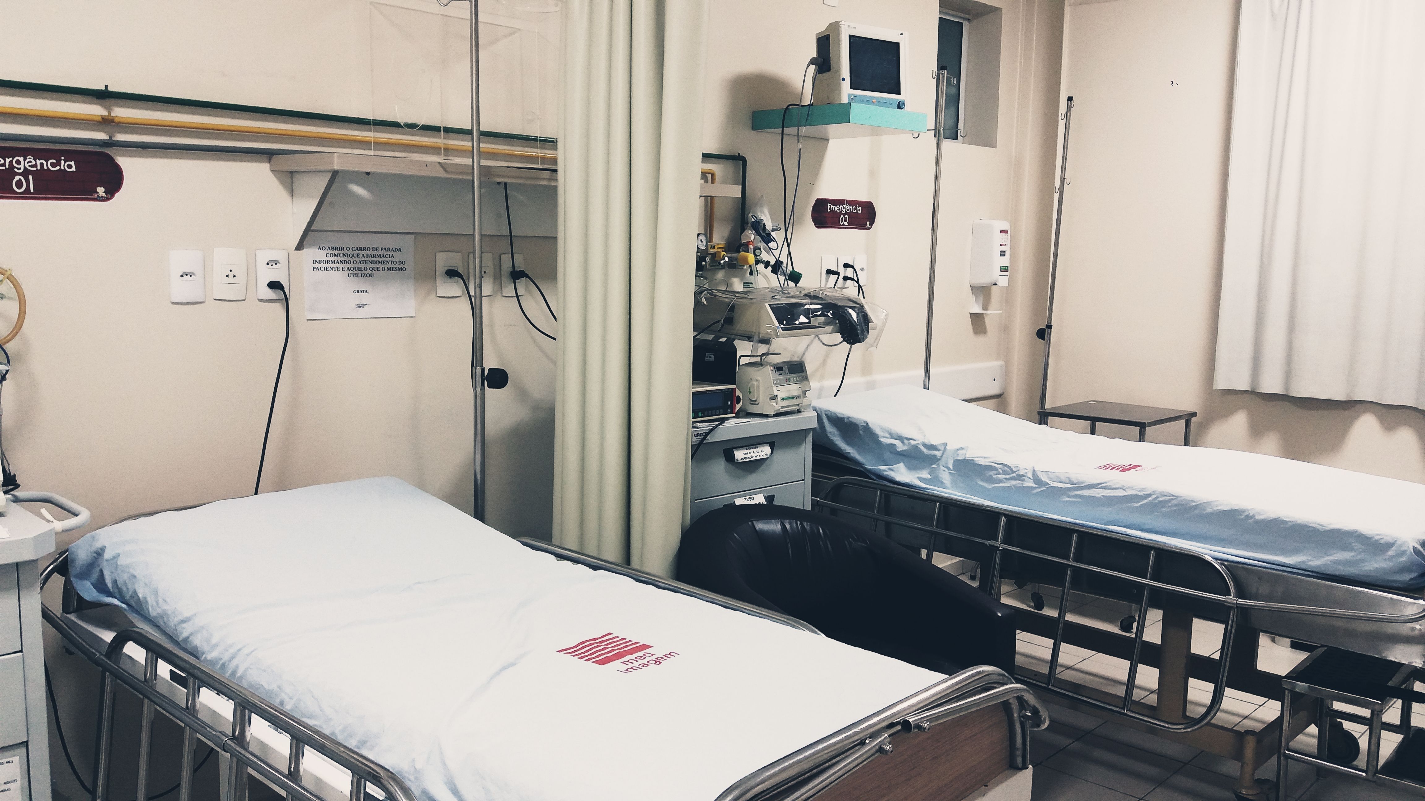 Empty hospital beds with monitoring equipment in an emergency ward