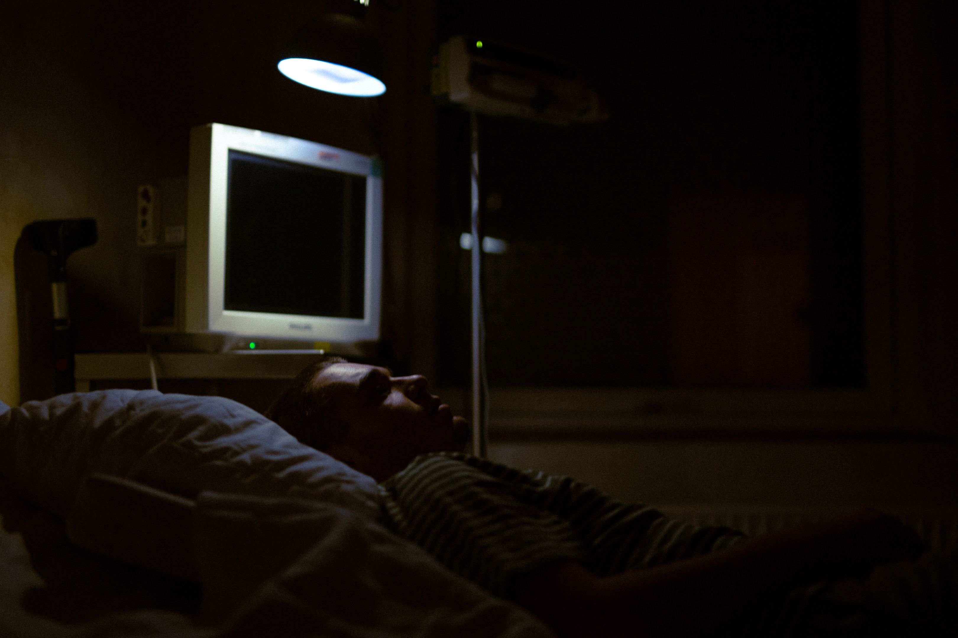 Patient resting in a hospital bed during acute medical care