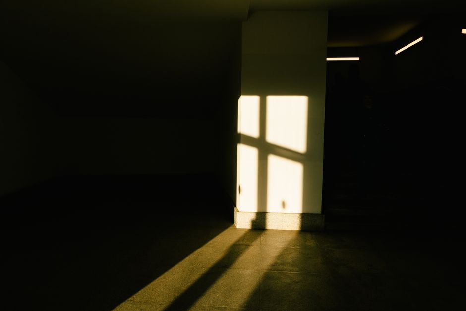 Play of light and shadow inside a building, creating an abstract and dramatic effect.