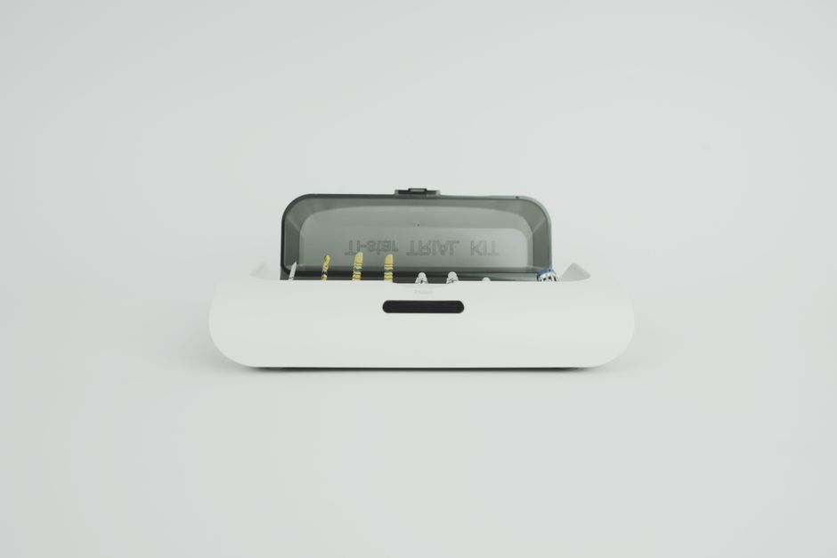 A sleek and modern dental instrument kit displayed on a minimal white surface, ideal for medical themes.