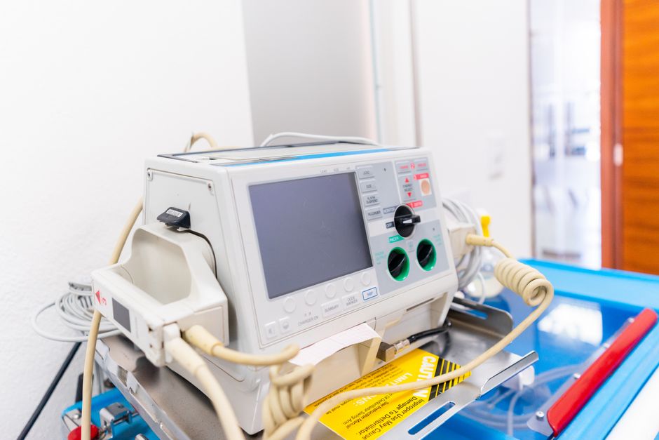 High-resolution image of a modern defibrillator in a hospital environment.