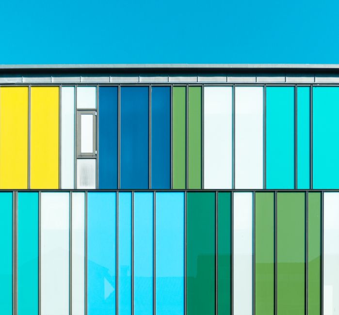 Vibrant modern glass facade showcasing multi-colored patterns in Fredrikstad, Norway.