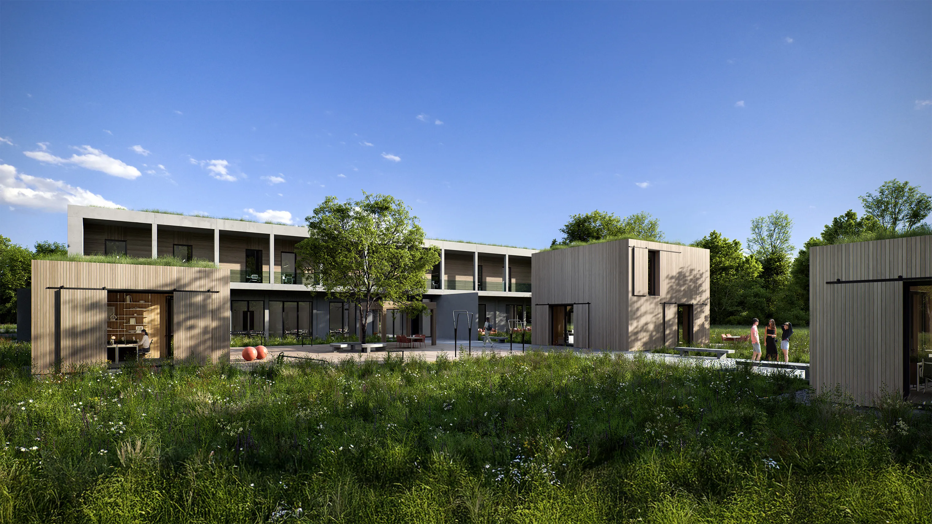 Außenansicht eines Verwaltungsgebäudes mit vorgelagerten Tiny Houses