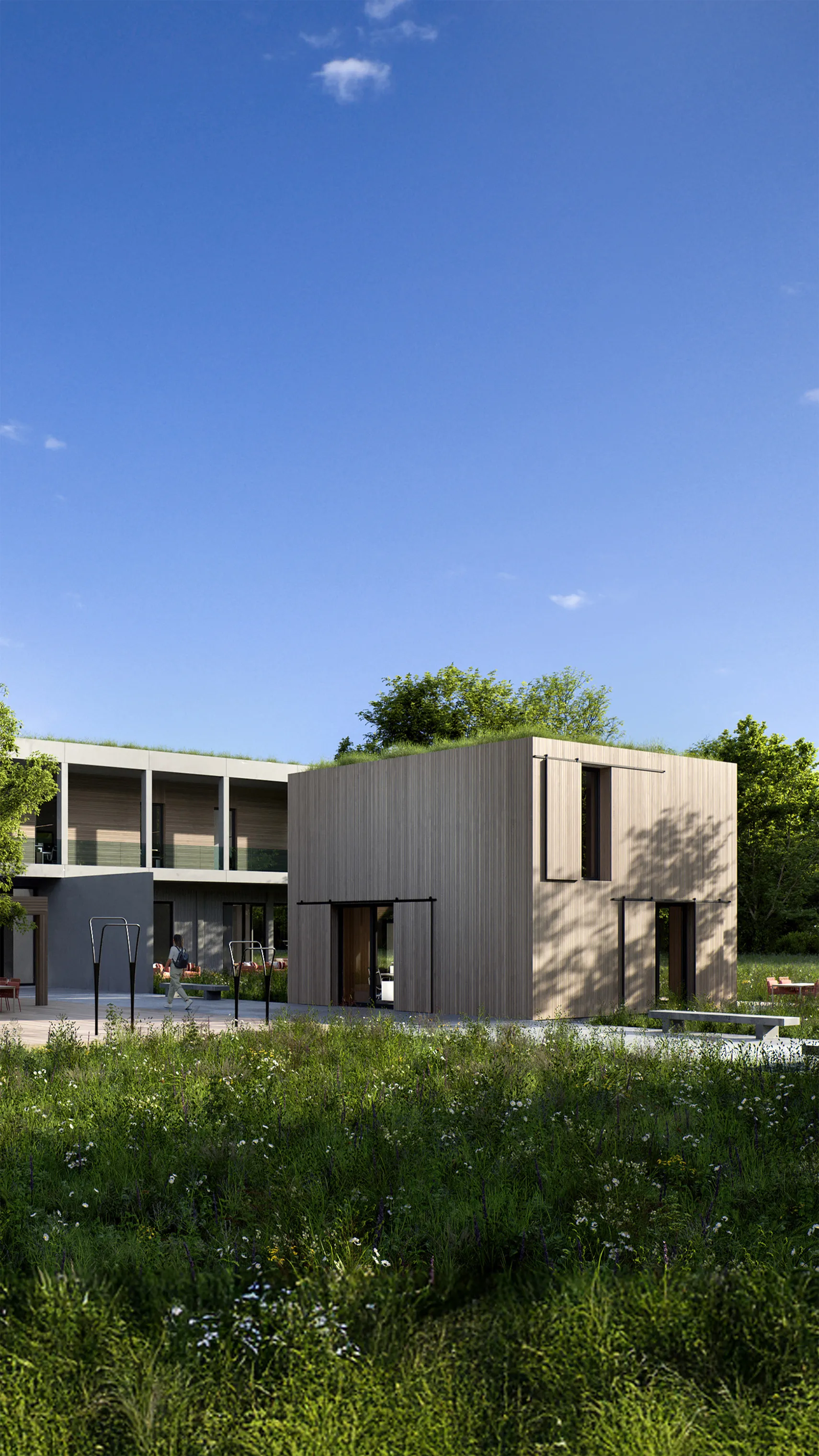 Außenansicht eines Verwaltungsgebäudes mit vorgelagerten Tiny Houses