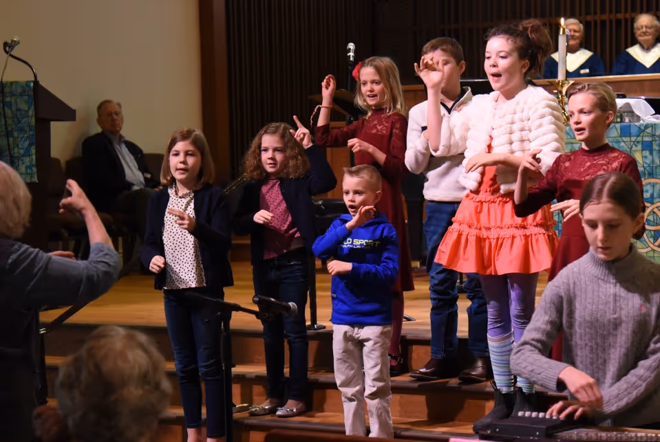 A children's choir sings during a worship service.