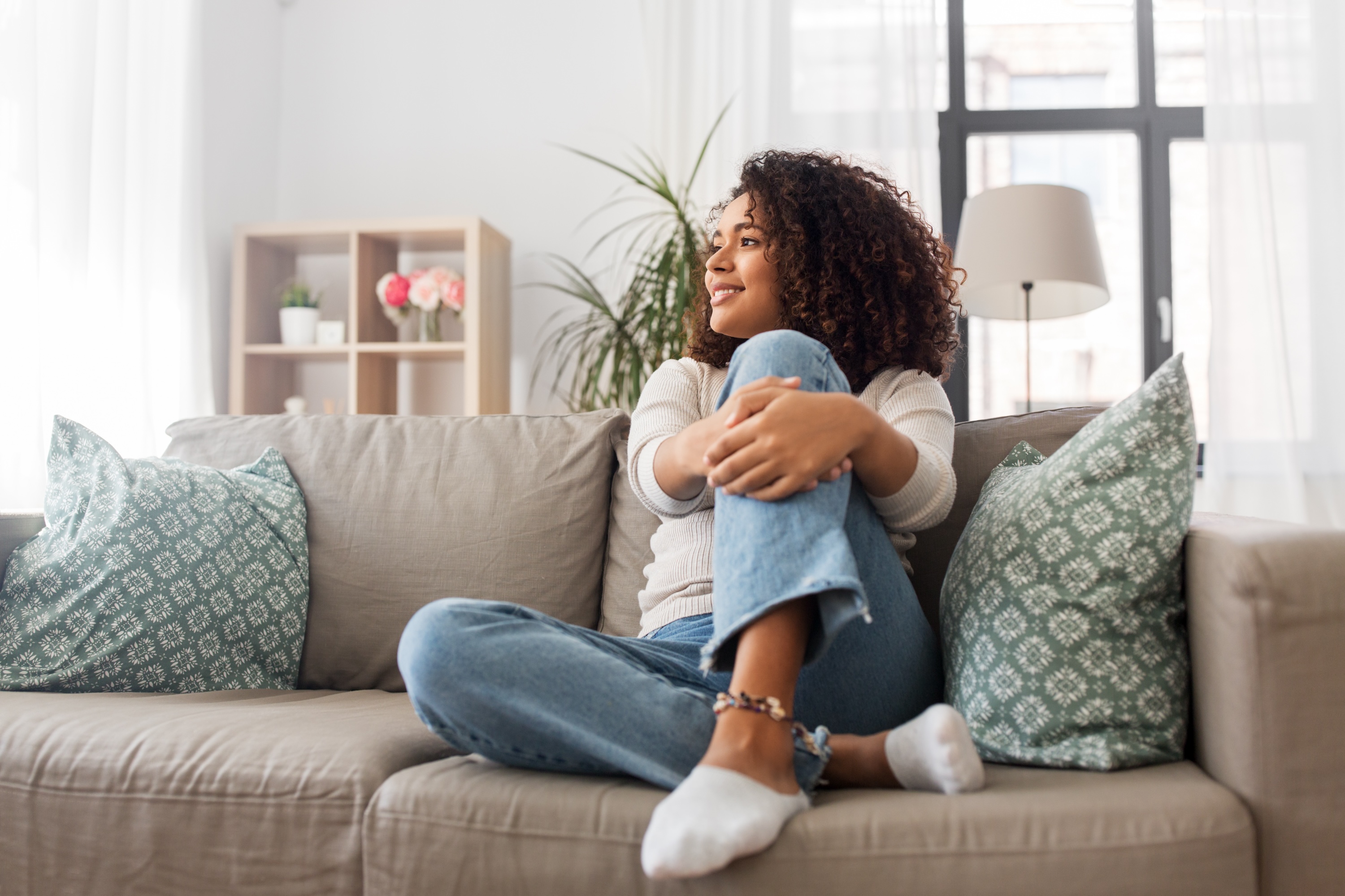 Resident relaxing on the couch in a bright living room at Wildcat Vista, Godley