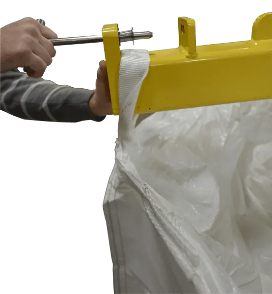 Model MTD-2.5K Bulk Bag Unloader Discharger showing operator securing bulk bag loop with locking pin