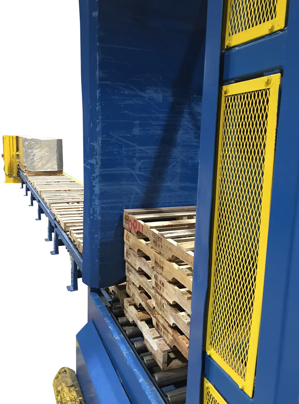Pallet Destackers transporting wrapped pallet load on long conveyor line in industrial facility