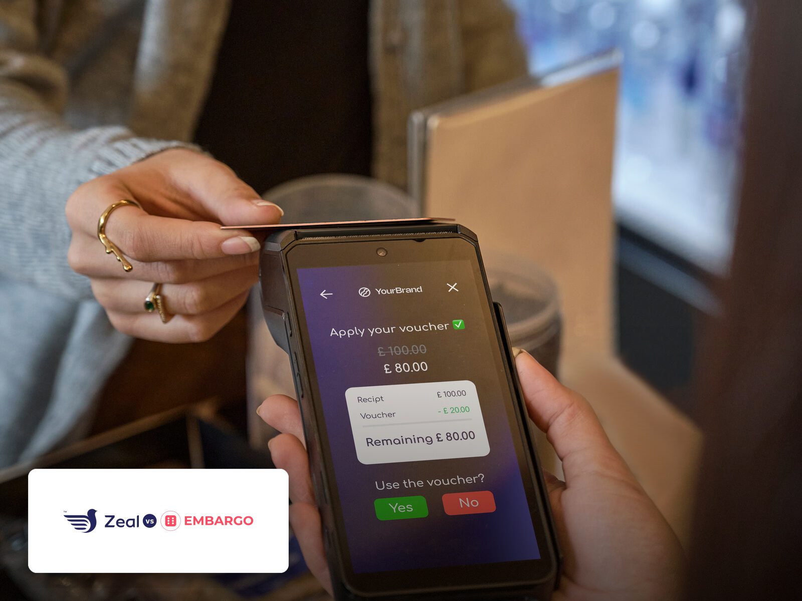Customer tapping a phone on a Zeal-enabled card machine showing loyalty stamps